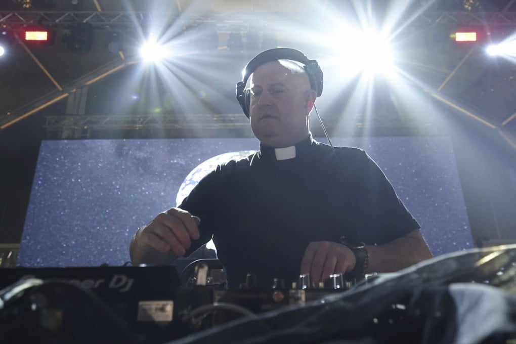 Roman Catholic priest Guilherme Peixoto plays a DJ set together with the Portuguese Army Symphonic Band during Army Day celebrations in Viana do Castelo, Portugal, on October 26, 2023. Peixoto hopes his music can help bring more young people into the church. Photo: AP