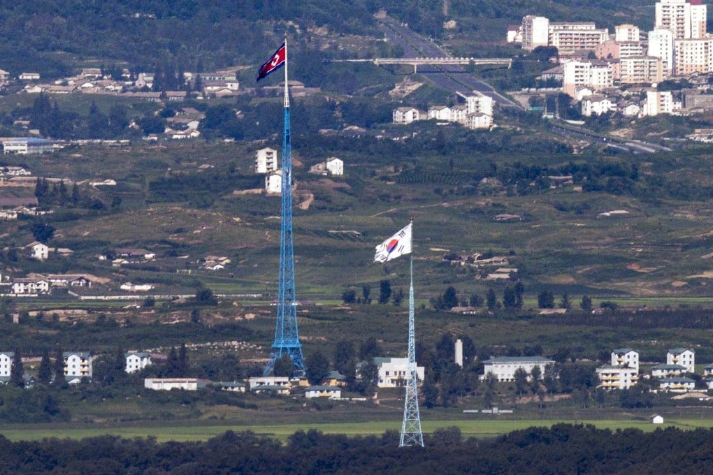 Flags of North Korea (rear) and South Korea from the border area between the two Koreas in Paju, South Korea. South Korea plans to launch its first home-grown spy satellite at the end of November. File photo: AP