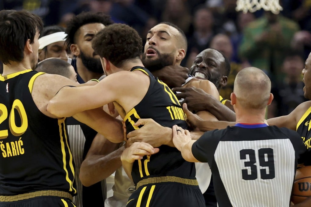Golden State Warriors’ Draymond Green puts Rudy Gobert in a chokehold, which gets him a five-game suspension. Photo: AP