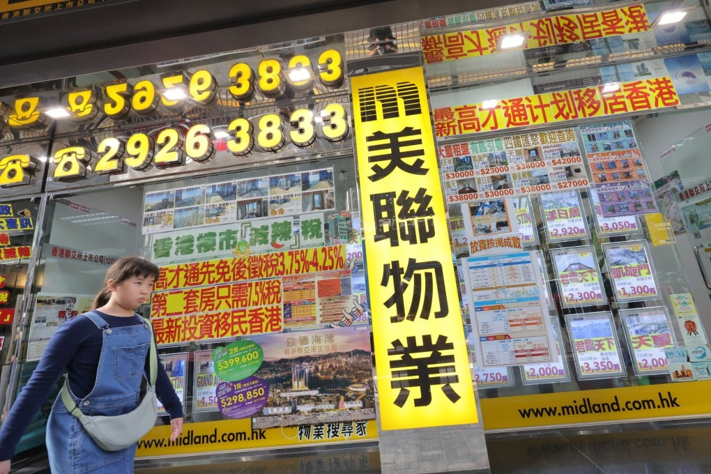 People passing by Midland Realty’s Austin Road branch in Jordan. The Competition Commission is taking legal action against Midland Holdings and two of its real estate agencies, accusing them of conspiring with other firms to set minimum commission rates. Photo: Jelly Tse