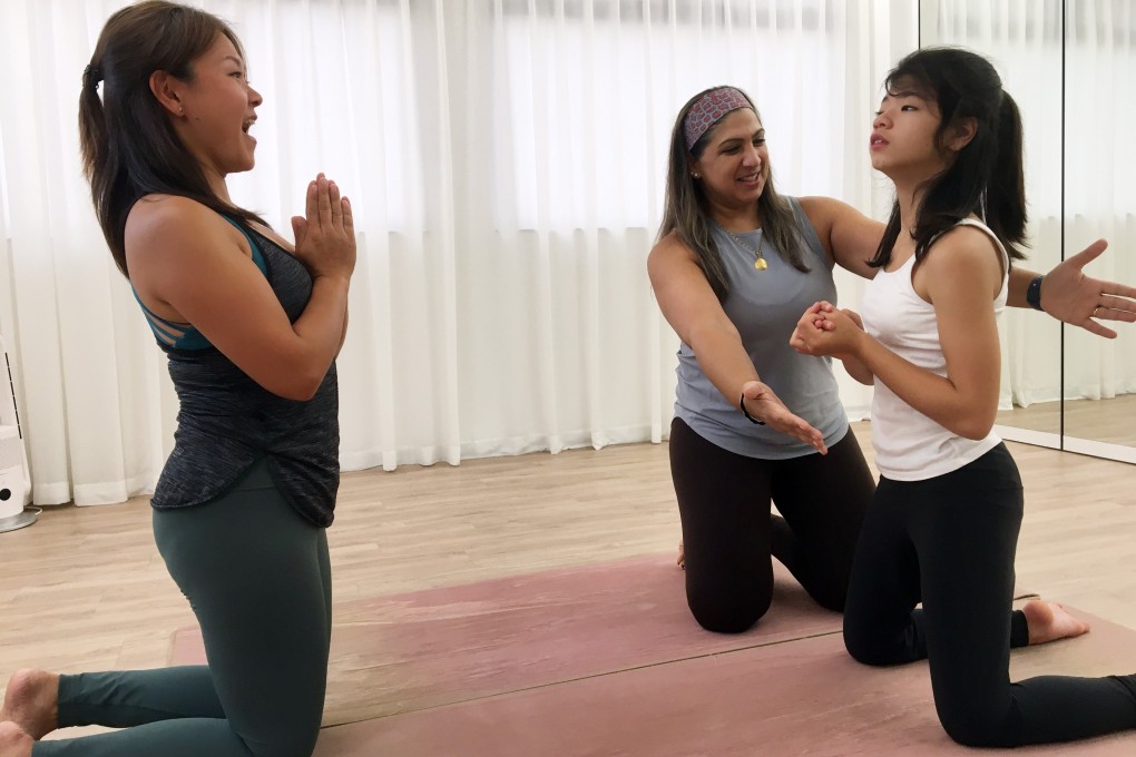 Yoga poses can be especially challenging for individuals such as Elia (right), who has hemorrhagic telangiectasia, a disease in which blood vessels do not develop properly. Photo: Cindy Sui