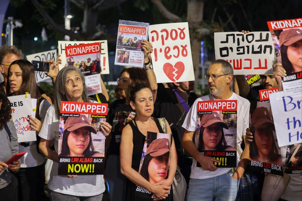 Relatives and supporters of hostages held in Gaza since Hamas’s October 7 attack on Israel hold placards and images of those taken during a demonstration outside the defence ministry in Tel Aviv on Wednesday. Photo: AFP