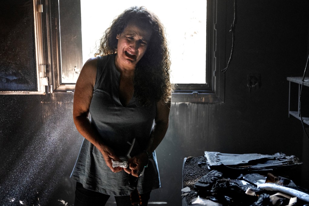 A woman, whose mother and niece were killed in Hamas’ attack on October 7, cries in the burned-out remains of her mother’s home in Kibbutz Nir Oz, in southern Israel, on October 30. Three members of the family - two children and their father - were kidnapped. Photo: Reuters