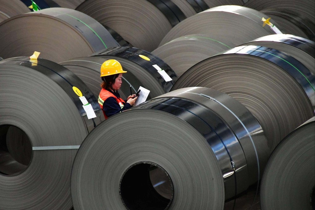 A quality inspector runs checks on finished stainless steel foil coils at a Tsingtuo Group production facility. Photo: Xinhua