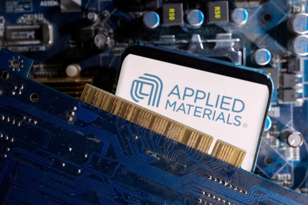 A smartphone displaying Applied Materials' logo is placed on a computer motherboard in this illustration taken on March 6, 2023. Photo: Reuters