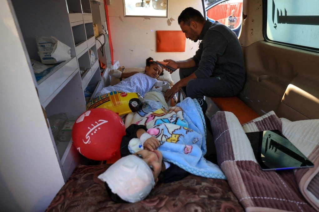 Two Palestinian children wounded in Israeli strikes, lie in an ambulance outside Al-Aqsa hospital in Deir al-Balah in the centre of the Gaza Strip, as they start the process of being evacuated to the UAE in a humanitarian flight from al-Arish in Egypt. Photo: AFP