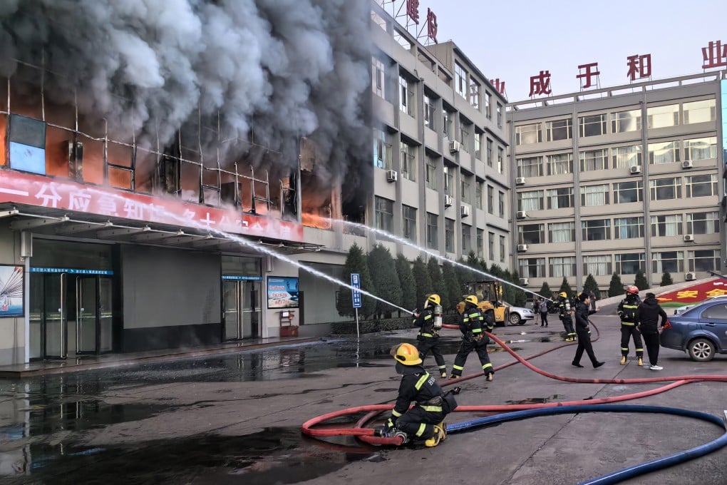 Firefighters fight the blaze at the Yongju Coal Industry Joint Building in Luliang city, Shanxi province. Photo: Xinhua