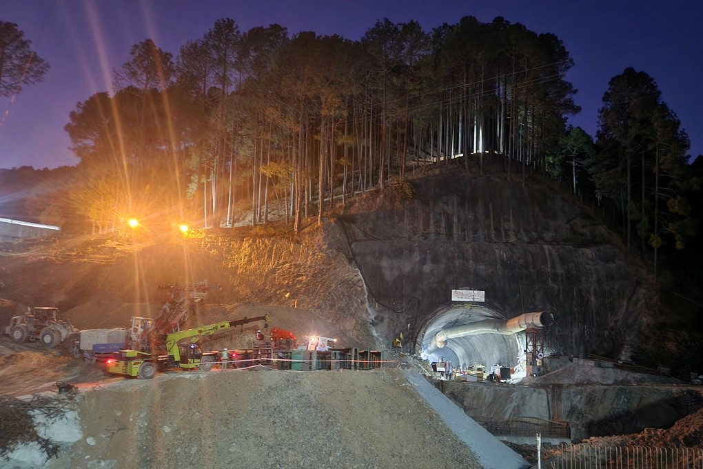 Rescuers on Sunday move machines past a tunnel where workers are trapped after a portion of the tunnel collapsed in the northern state of Uttarakhand, India. Photo: Reuters