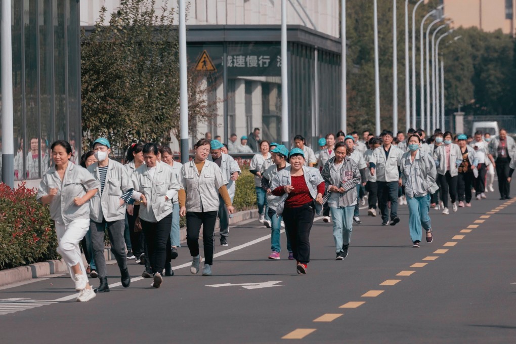 Some workers run to have lunch at the Hualida clothing factory canteen in Changzhou, Jiangsu province, on November 14. 
Retirement age in China is among the lowest globally – 60 for men, 55 for white-collar women. But with better nutrition and healthcare, workers in this cohort are retiring with longer, healthier lives ahead of them. Photo: EPA-EFE