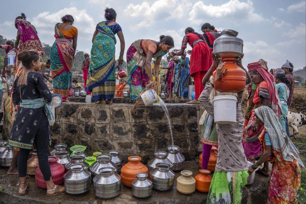 Women gather around a well to draw water in the village of Telamwadi, northeast of Mumbai, India. Activists are urging policymakers to respond to climate change’s disproportionate impact on women and girls, especially where poverty makes them more vulnerable. Photo: AP