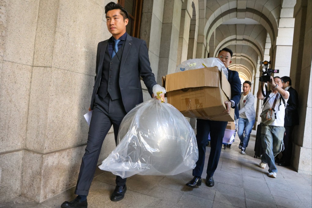 Police carrying the evidence related to the case out of the court after the ruling was declared. Photo: Dickson Lee