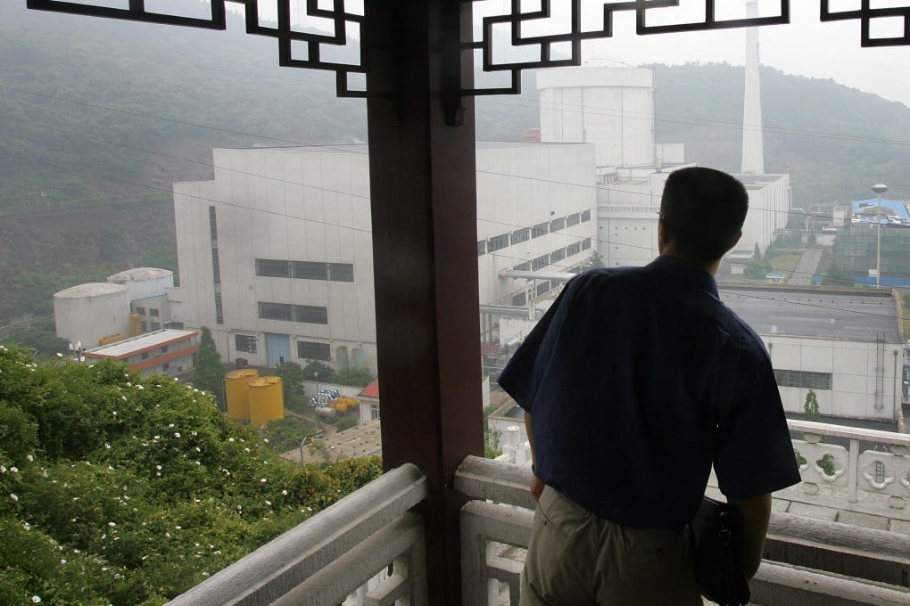 A man looks out towards the Qinshan Nuclear Power Plant while taking shelter from the rain at a hilltop overview on the outskirts of Hangzhou, Zhejiang province. Nuclear energy is an increasingly important part of Asia’s energy mix as nations pursue decarbonisation goals. Photo: AFP