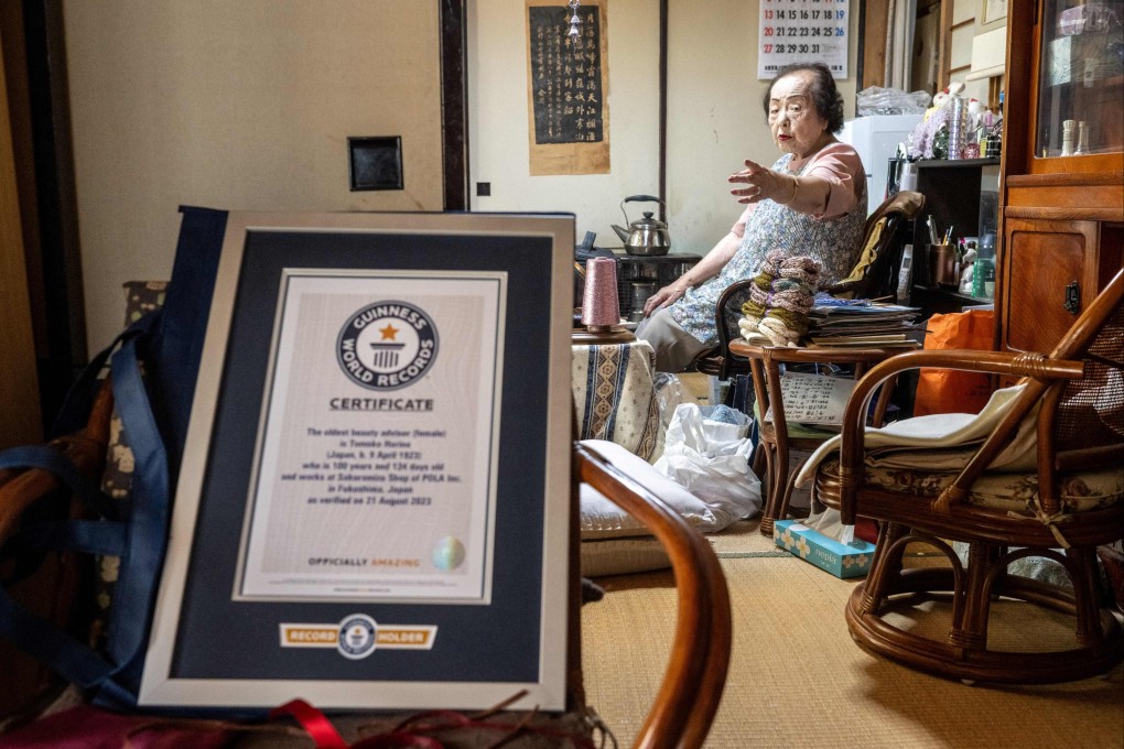 Tomoko Horino, 100 seen with her Guinness World Records Certificate recognising her as the oldest beauty adviser in the world. Photo: AFP