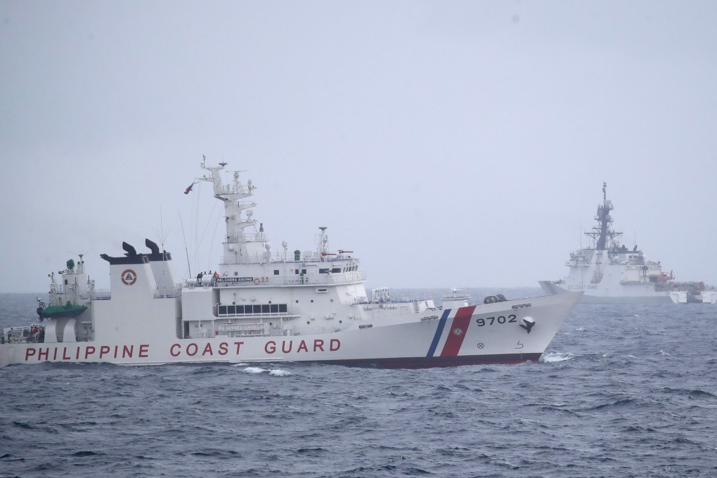 A Philippine Coast Guard patrol ship and a US Coastguard Cutter  maneuver during a maritime drill in the disputed South China Sea. Photo: EPA-EFE