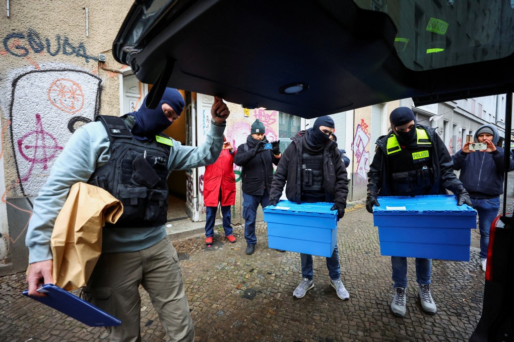 German police officers carry evidence collected at an apartment building during a raid against people supporting the Palestinian Islamist group Hamas, in Berlin. Photo: Reuters