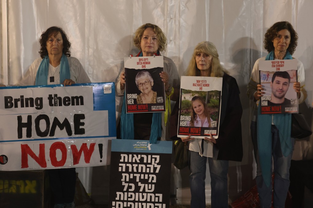 Women hold photos of people abducted by Hamas militants outside the Tel Aviv museum on Wednesday. Photo: EPA-EFE