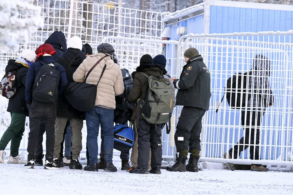 Finnish Border Guards check the documents of arriving migrants at the international border crossing at Salla, northern Finland. Photo: AFP