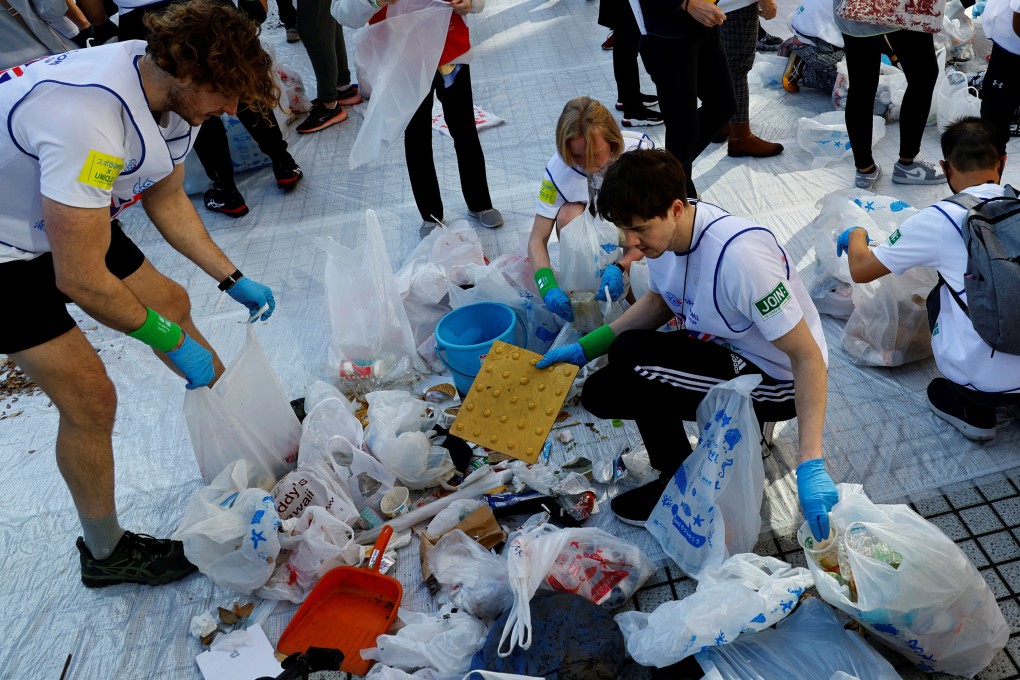 Members of team UK sort out garbage they collected during the “Spogomi World Cup”. Photo: Reuters
