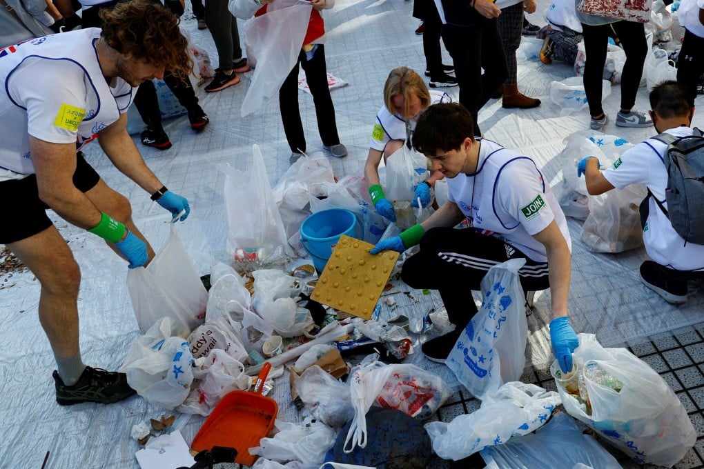 Members of team UK sort out garbage they collected during the “Spogomi World Cup”. Photo: Reuters