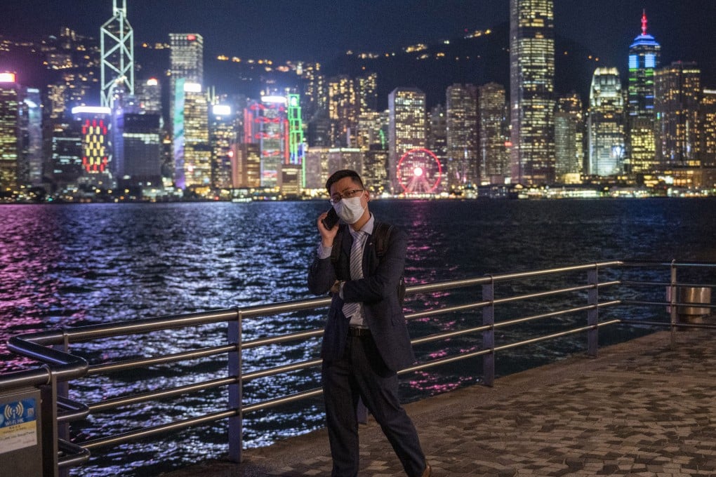 A man talks on his phone in front of the skyline in Hong Kong. The longer term implications of mainland China’s slower growth for the city are profound. Photo: AP
