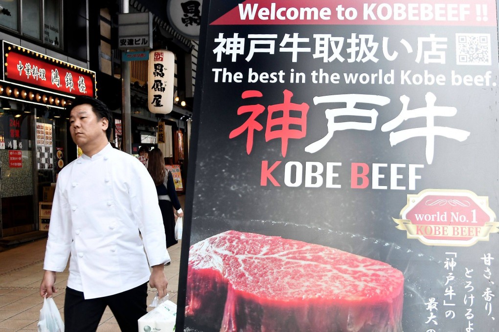 A man walk past a poster showing Kobe beef in the centre of Kobe, Japan. It is one of many places in the world associated with a food or drink. Photo; AFP