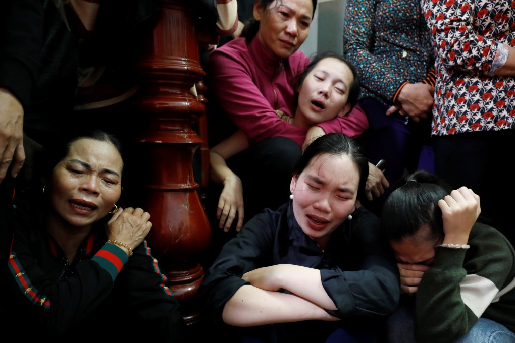 Relatives of John Hoang Van Tiep, one of 39 people who died  in a truck container in Britain, mourn during his funeral in Nghe An province, Vietnam, in 2019. Photo: Reuters
