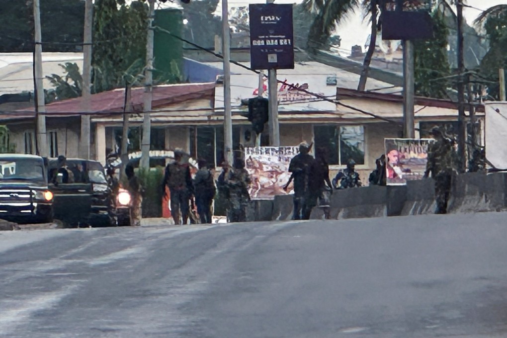 Hooded armed men in military fatigues in Freetown, Sierra Leone, after unidentified gunmen attacked a military barracks. Photo: Reuters