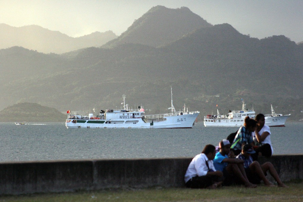 Locals sit on a wall situated on the foreshore of the harbour in the Fiji capital of Suva. Fiji’s deep water port access appeals to Beijing as the contest for influence across the Pacific heats up. Photo: Reuters