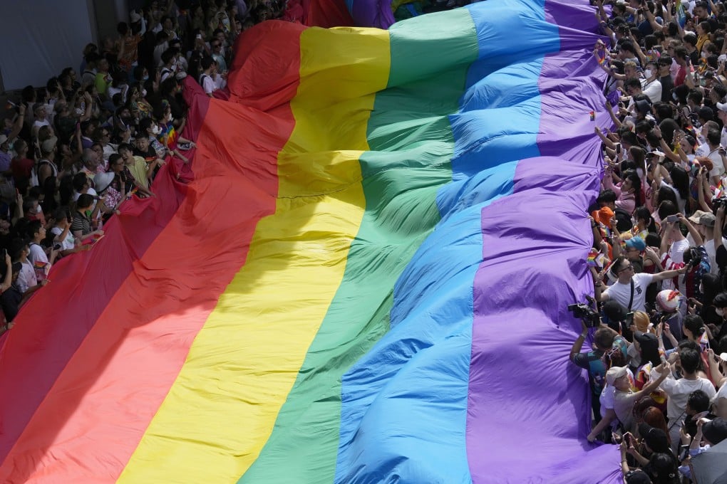 Participants of a Pride Parade in Bangkok, Thailand, on June 4 hold a rainbow flag. Thailand will soon join the ranks of countries and regions who have made same-sex marriage legal. Photo: AP