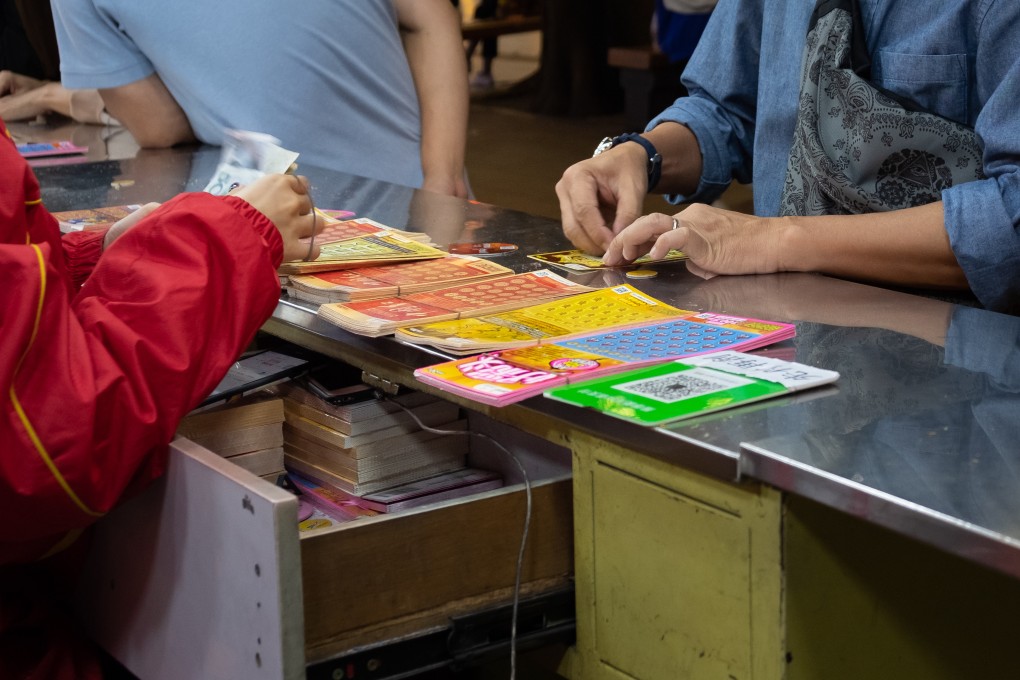 A customer scratches off lottery tickets in China’s Guangdong province. Photo: Shutterstock