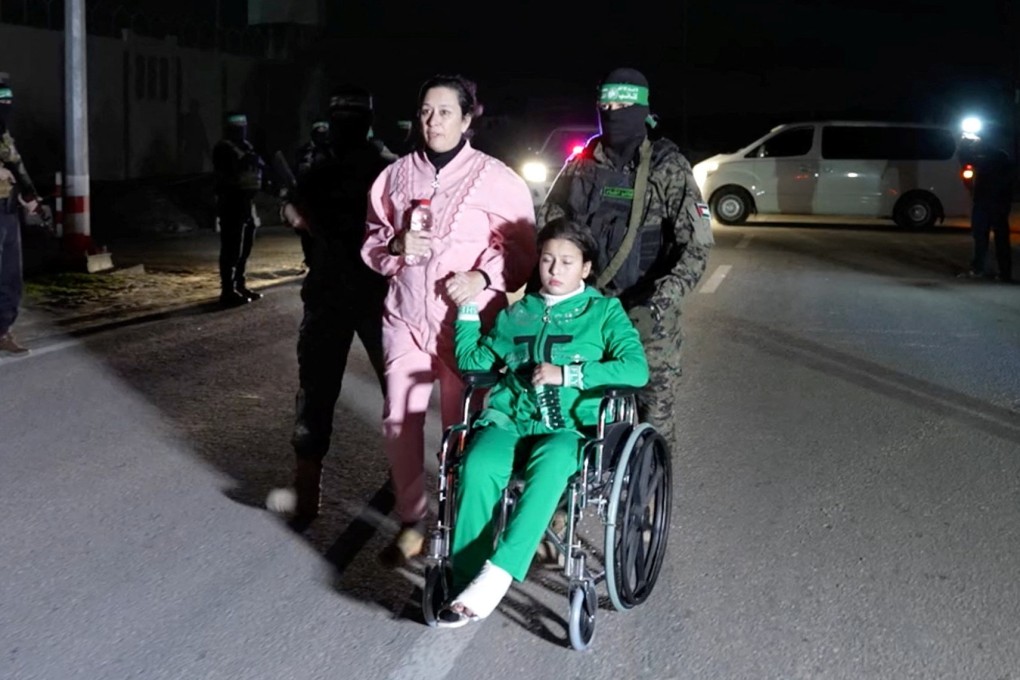 Hostages being handed over by Hamas militants in this screengrab taken from video released November 27. Photo: Hamas Military Wing via Reuters