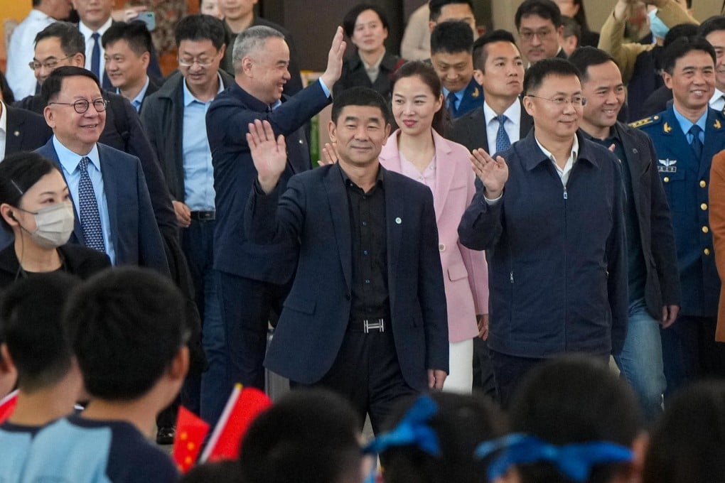 Astronauts Liu Boming (centre) and Wang Yaping (second row, centre) arrive in Hong Kong on a four-day visit to the city. Photo: Sam Tsang