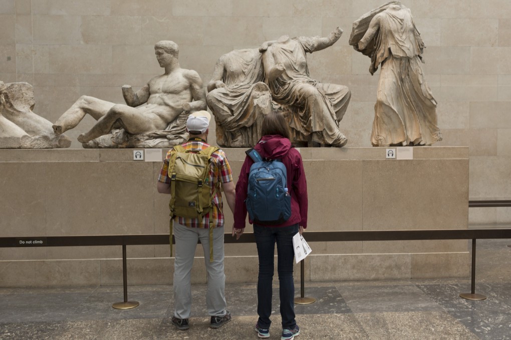 Visitors admire the ancient Greek Parthenon’s Elgin Marbles Metopes in the British Museum. Photo: Getty Images