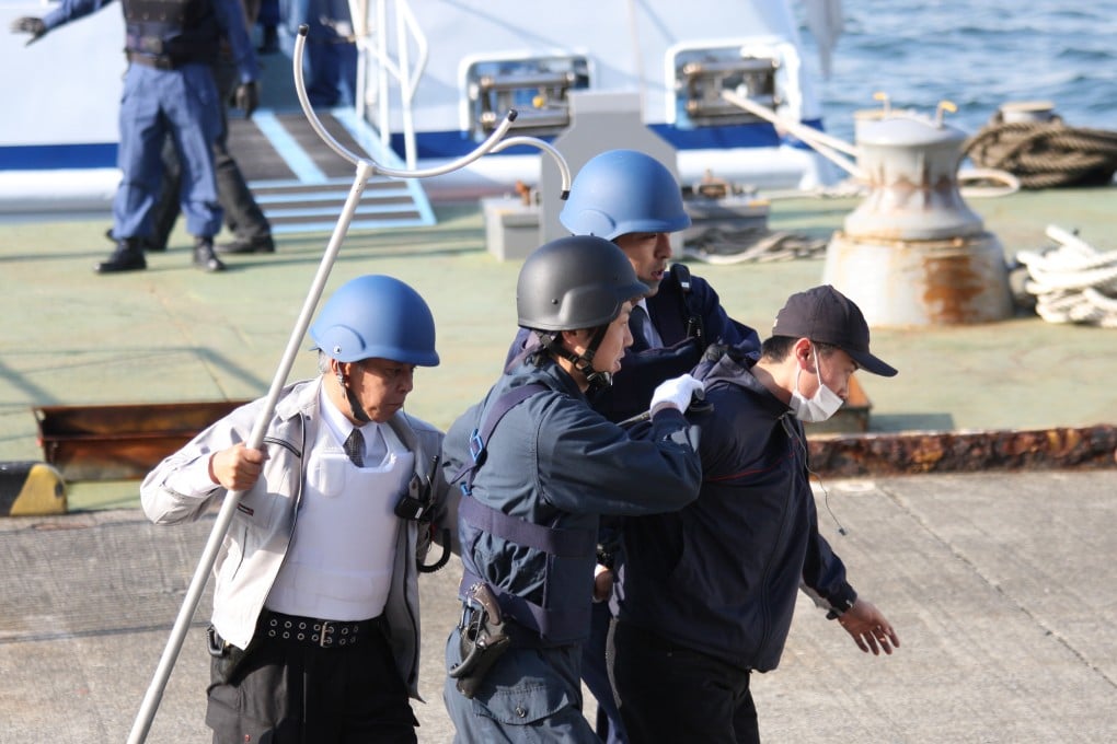 Officers take part in a counter-terrorism training exercise at a public venue in Osaka. The man in the white vest has a tool called a “sasumata”. Photo: Shutterstock