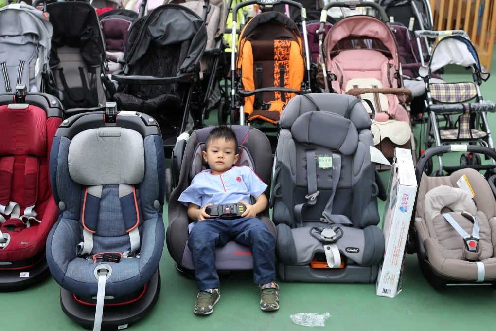 A child sits in a baby seat at a charity bazaar at Hong Kong’s Victoria Park in November 2018. Under current legislation, children under three years old and sitting in the front seat must use child safety seats, while children sitting at the back and children above three years old are not required to do so. Photo: Winson Wong