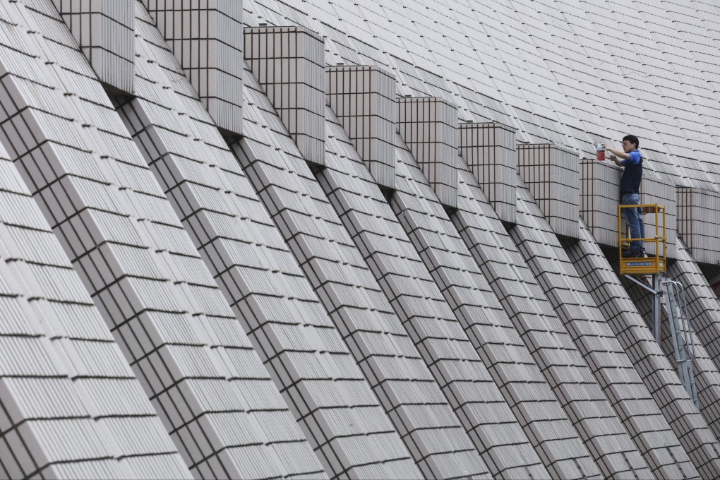 A worker cleans the dust-pink glazed ceramic tiles on the Hong Kong Cultural Centre in Tsim Sha Tsui. Photo: Felix Wong