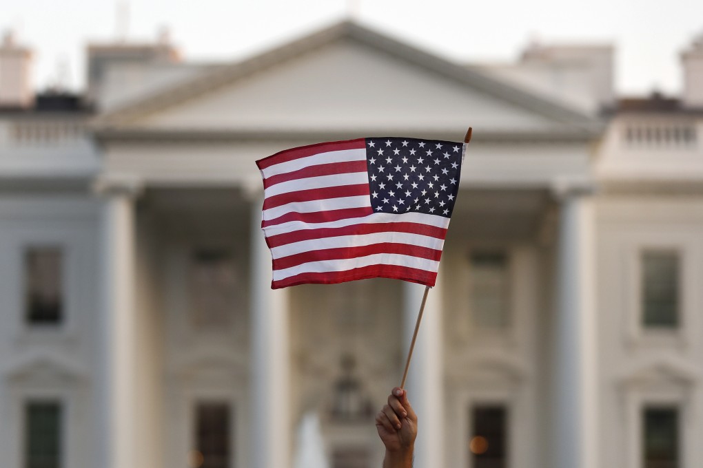 A United States flag is waved outside the White House in Washington. Photo: AP