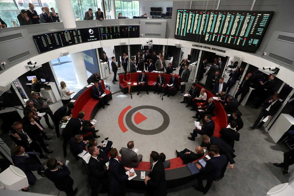 Traders work on the floor of the London Metal Exchange in London. Photo: Reuters