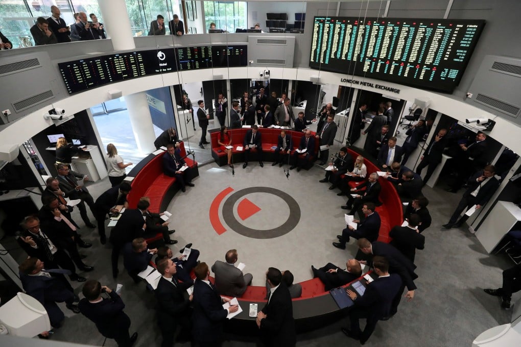 Traders work on the floor of the London Metal Exchange in London. Photo: Reuters