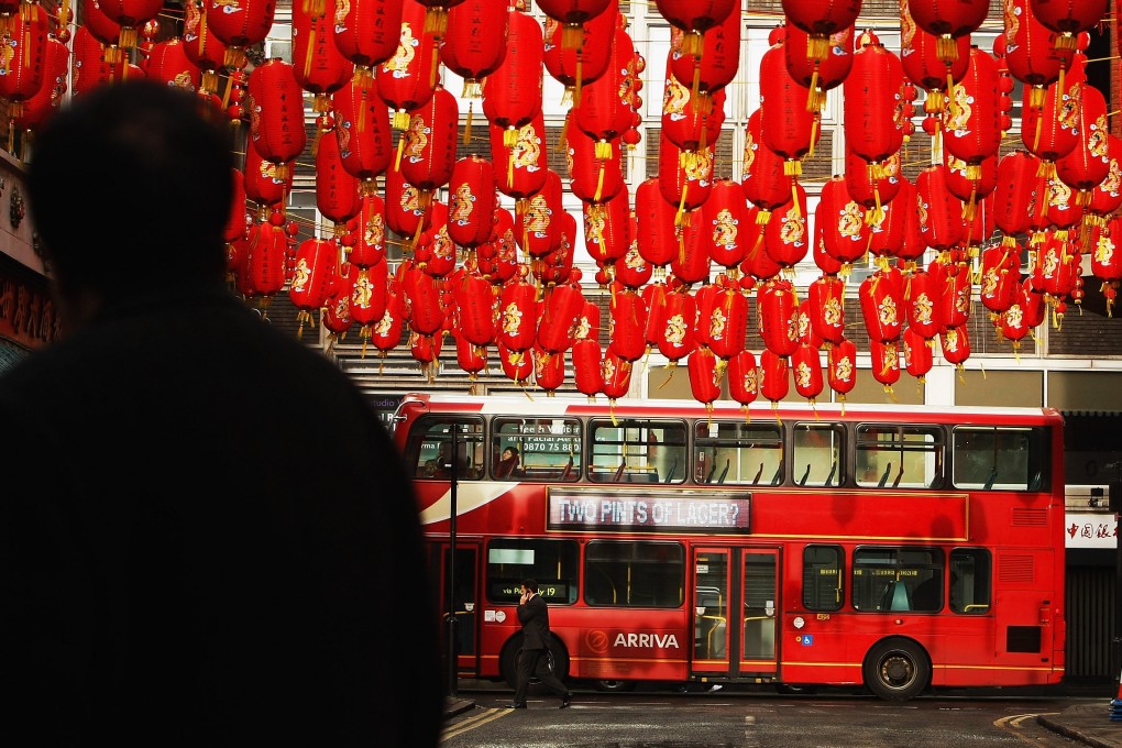 A bus passes the entrance to Chinatown in London. Although Hongkongers tend to travel frequently, a few trips overseas as a tourist are not the same as being a resident. Photo: Getty Images