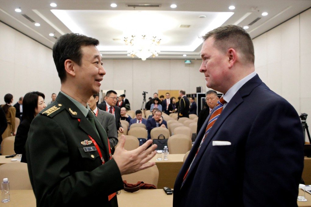 Chinese defence ministry spokesman Senior Colonel Wu Qian (left) speaks with former Pentagon official Chad Sbragia at the Xiangshan Forum in Beijing on October 30. Photo: Reuters