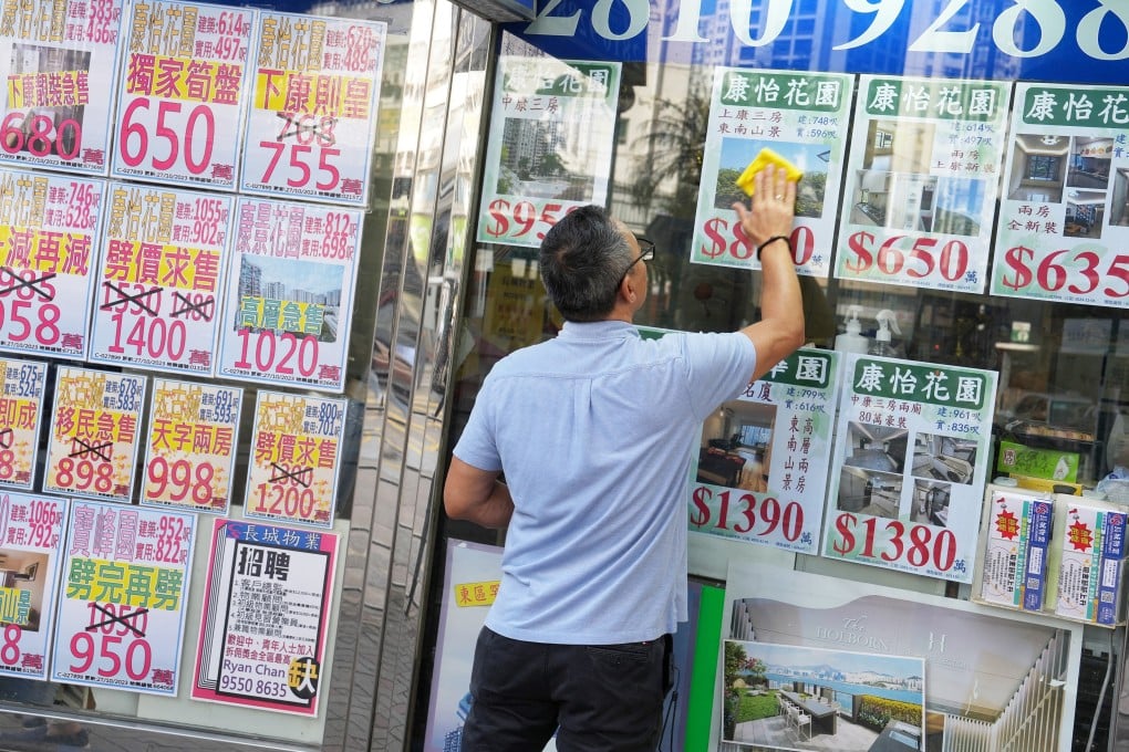 Property listings are displayed on the window of a real estate agency in Quarry Bay. Photo: Elson Li