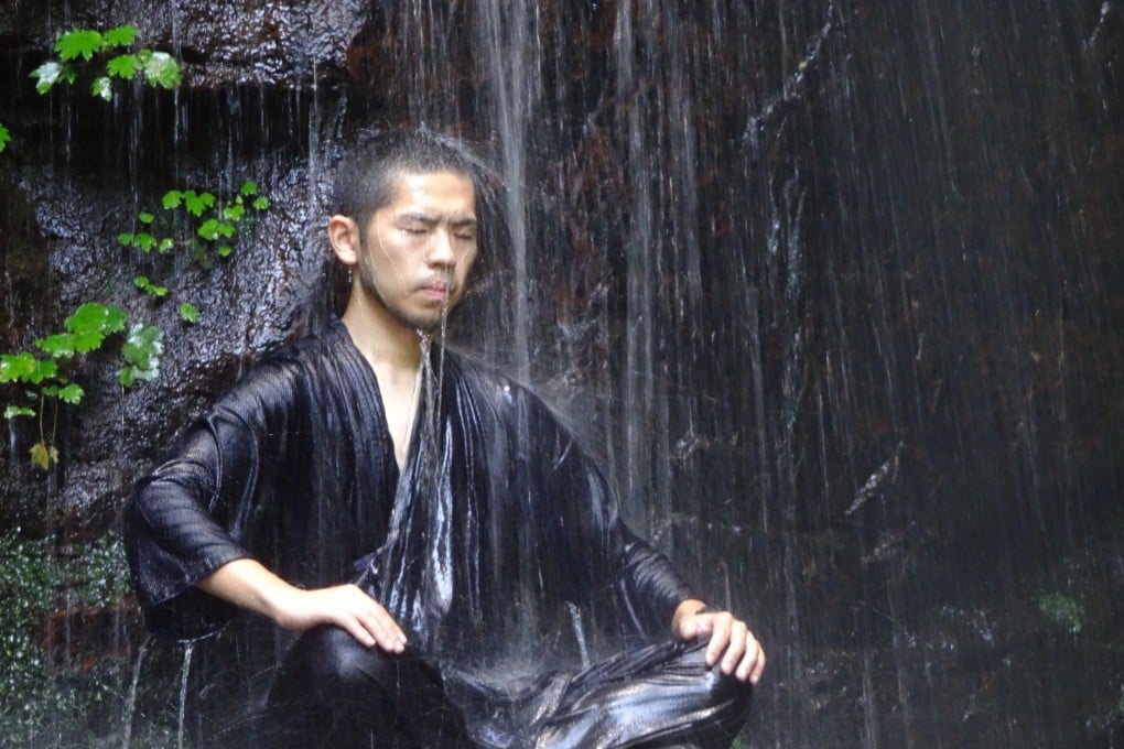 A guide teaches meditation under a waterfall at Akame 48 Nature Centre in Mie, Japan. Waterfall meditation is one of the many ways visitors to this home of the ninja can learn about the warrior’s ancient traditions. Photo: Greg Goodmacher