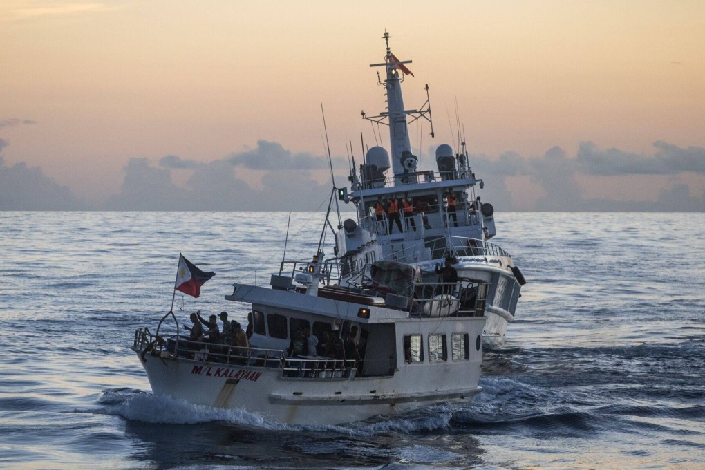 A Philippine boat on a resupply mission to the disputed Second Thomas Shoal moves past a Chinese coastguard ship in the South China Sea on November 10. Photo: Bloomberg
