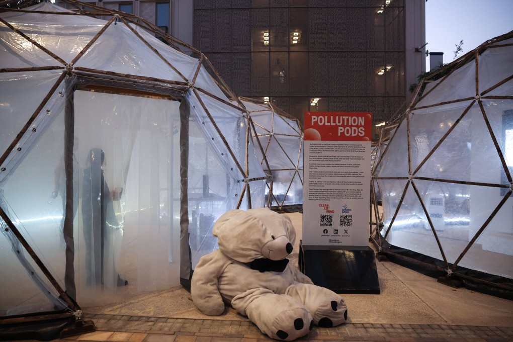 Attendees inside pollution pods, geodesic domes simulating air pollution levels from Beijing, London and New Delhi, at the Cop28 climate conference in Dubai, United Arab Emirates, on Friday. Photo: Bloomberg