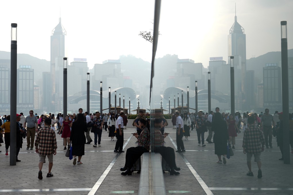 People visit at the waterfront in Tsim Sha Tsui. The Observatory says the current northeast monsoon will moderate gradually in the next couple of days. Photo: Sam Tsang