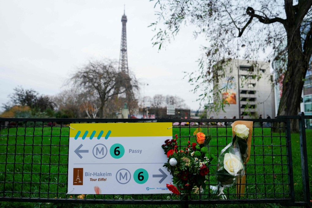 Flowers at the spot where a tourist was stabbed to death near the Eiffel Tower in Paris. Photo: AFP