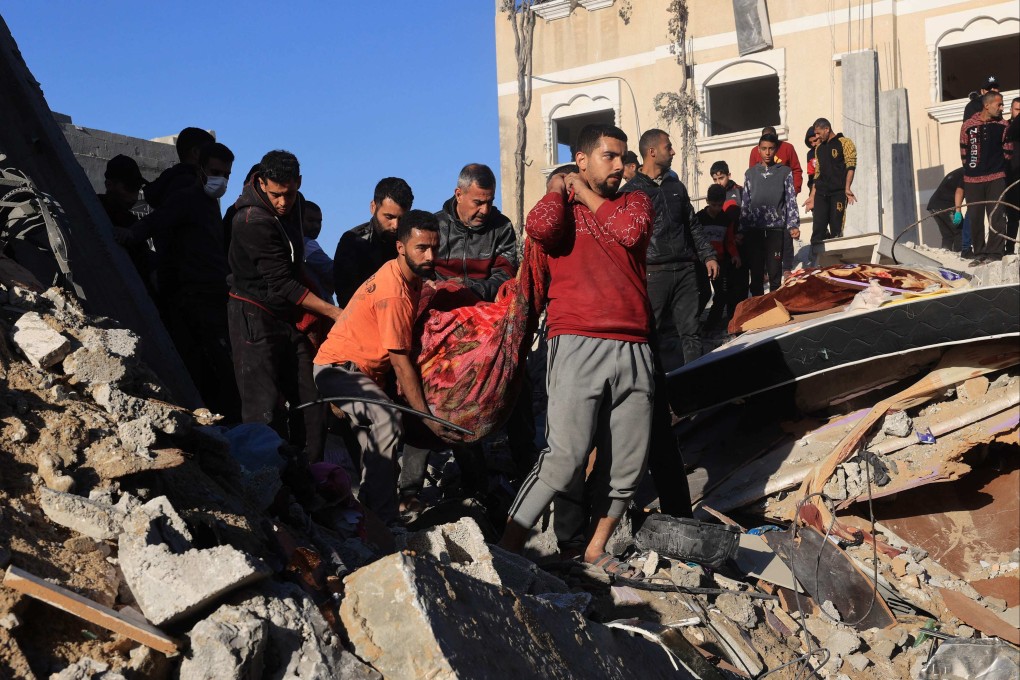 Men carry away the body of a victim recovered from rubble on Sunday in the aftermath of Israeli bombing in Rafah in southern Gaza. Photo: AFP