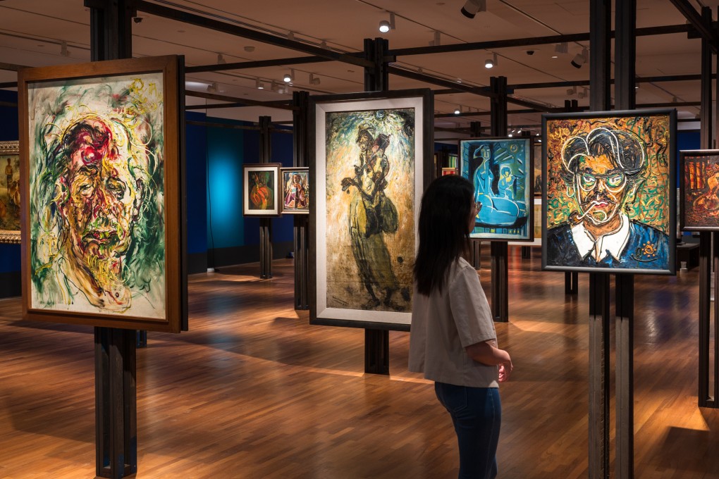 A visitor looks at paintings at the National Gallery Singapore’s “Tropical” exhibition, which explores colonial and postcolonial experiences in Southeast Asia and Latin America and features artists including Paul Gaugain, Frida Kahlo and David Medalla. Photo: National Gallery Singapore