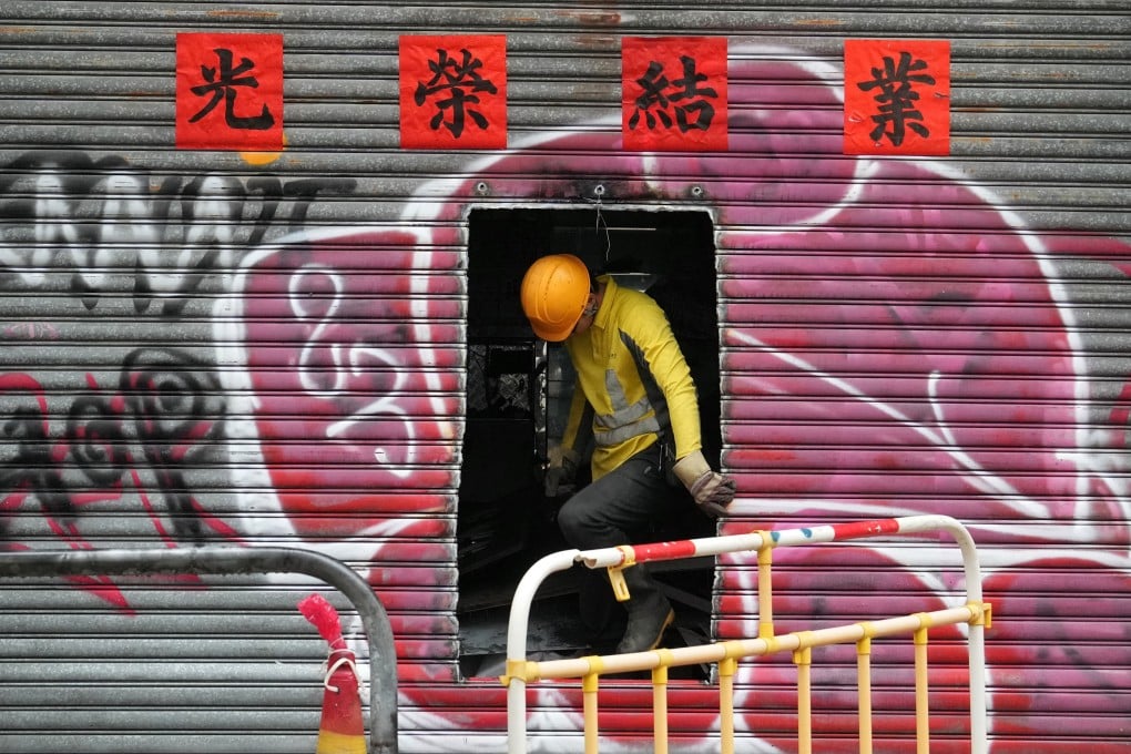 A worker cleans up a shop which has gone out of business in Wan Chai on October 18. High street shop rents in core districts grew 2.4 per cent in the third quarter, but the recovery of the retail sector still has some way to go. Photo: Elson Li